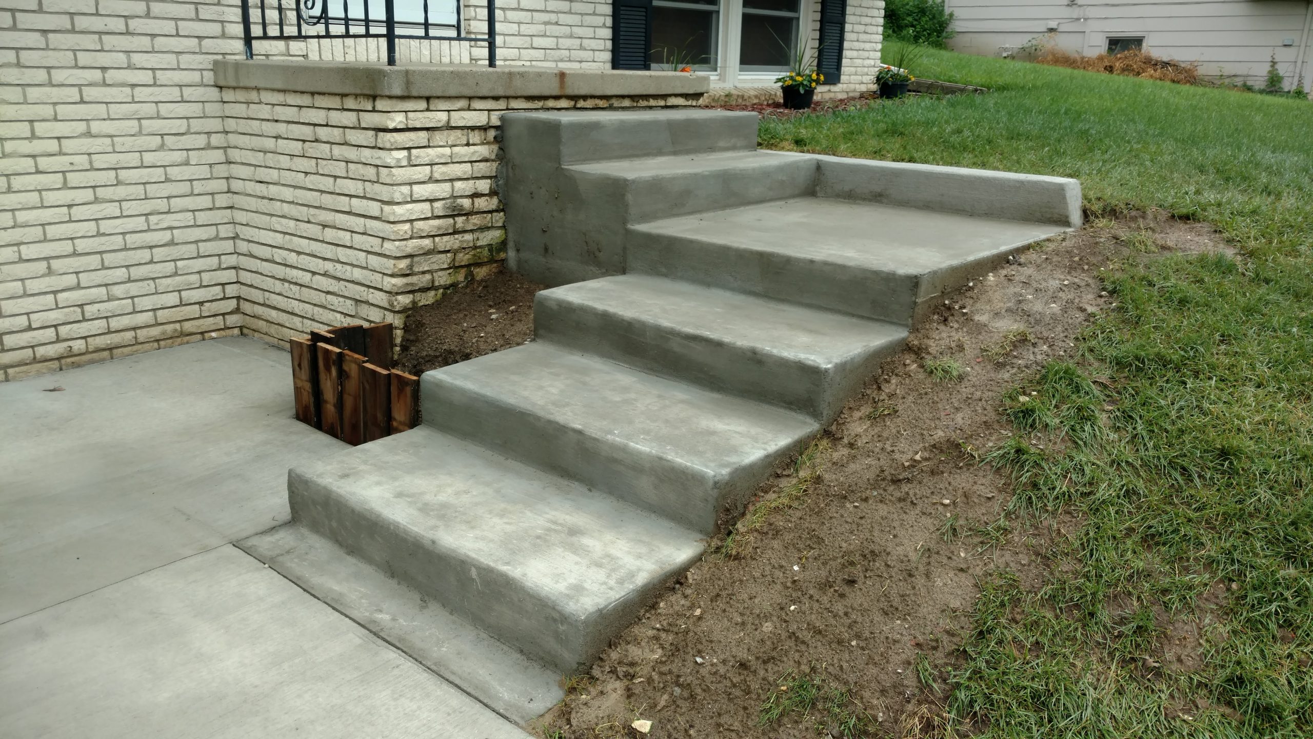 Durable concrete steps leading to a home entrance.